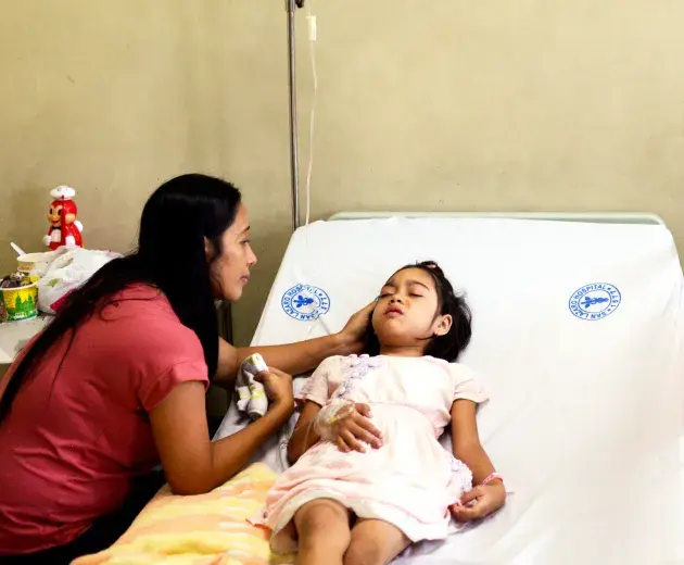 mother looks after a child in hospital 