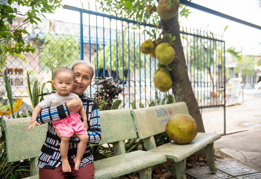 Nguyen Thi Den with her granddaughter, who contracted dengue, in the home of Thu Dau Mot